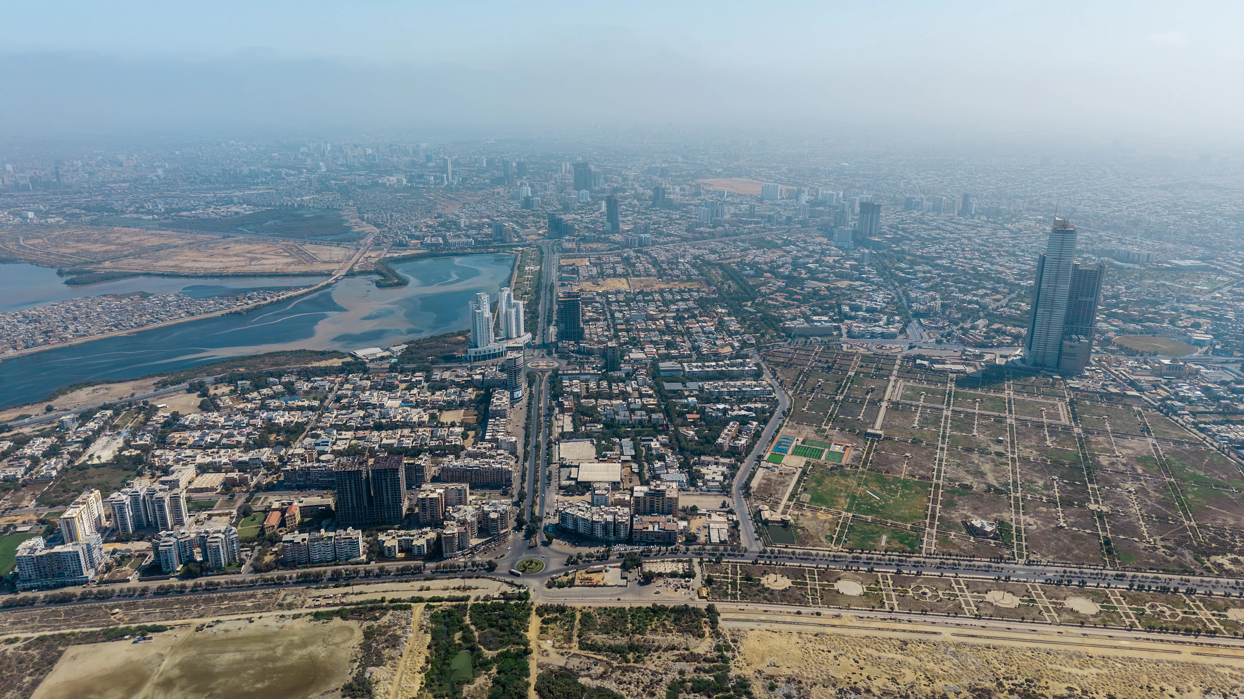 Aerial view of a sprawling cityscape with a river.