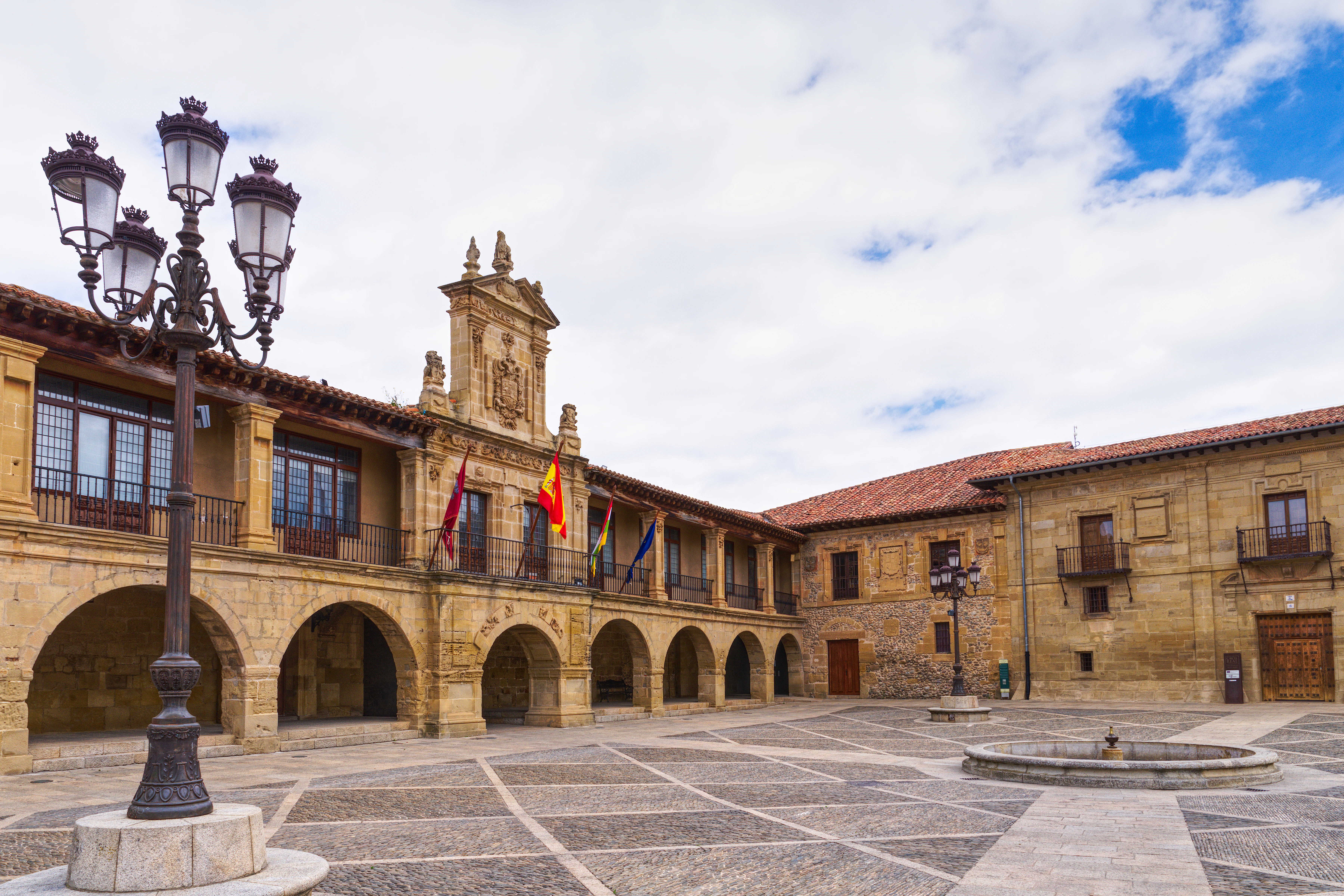 A large courtyard with a clock tower in the background