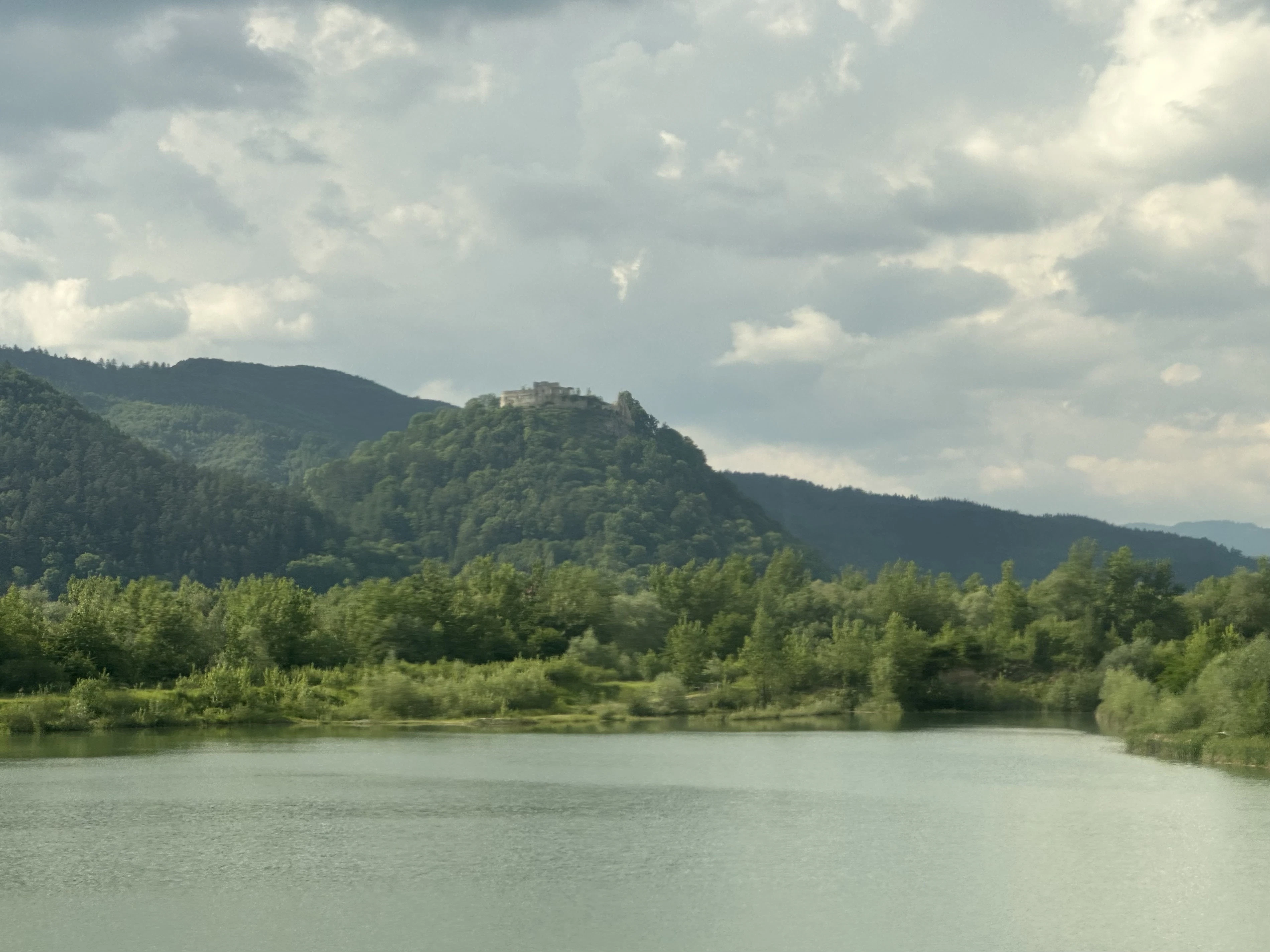 Scenic lake with lush green mountains.