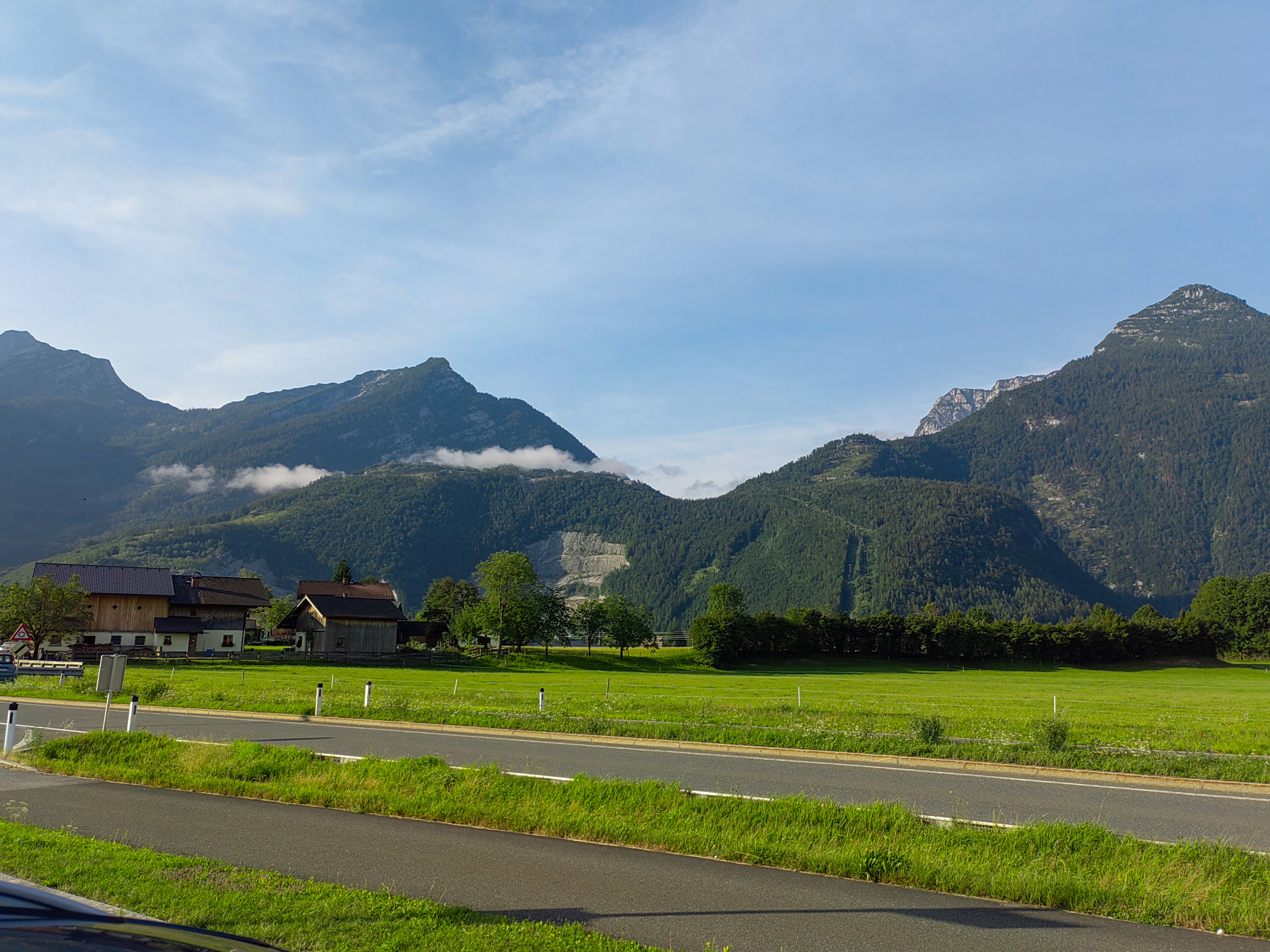 a green field with mountains in the background